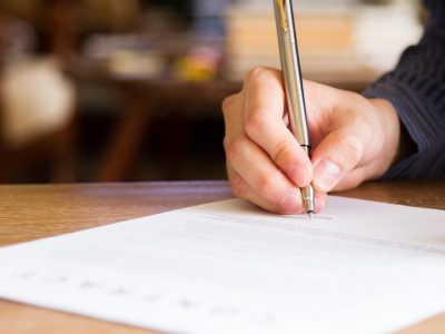 business man signing contract document on office desk